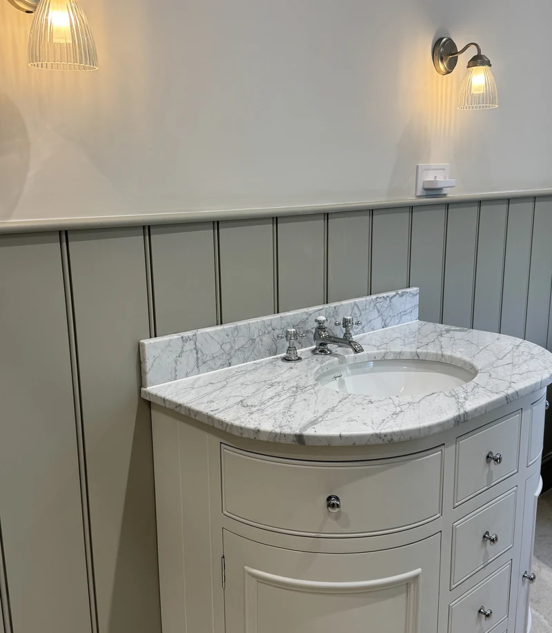 Curved vanity unit with a marble top and traditional tap, bathroom renovation Baldock