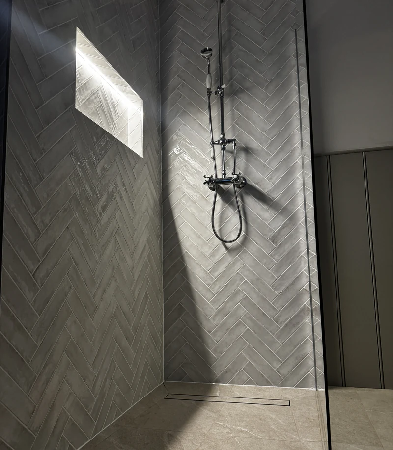Herringbone-tiled walk-in shower with a lit niche, Baldock