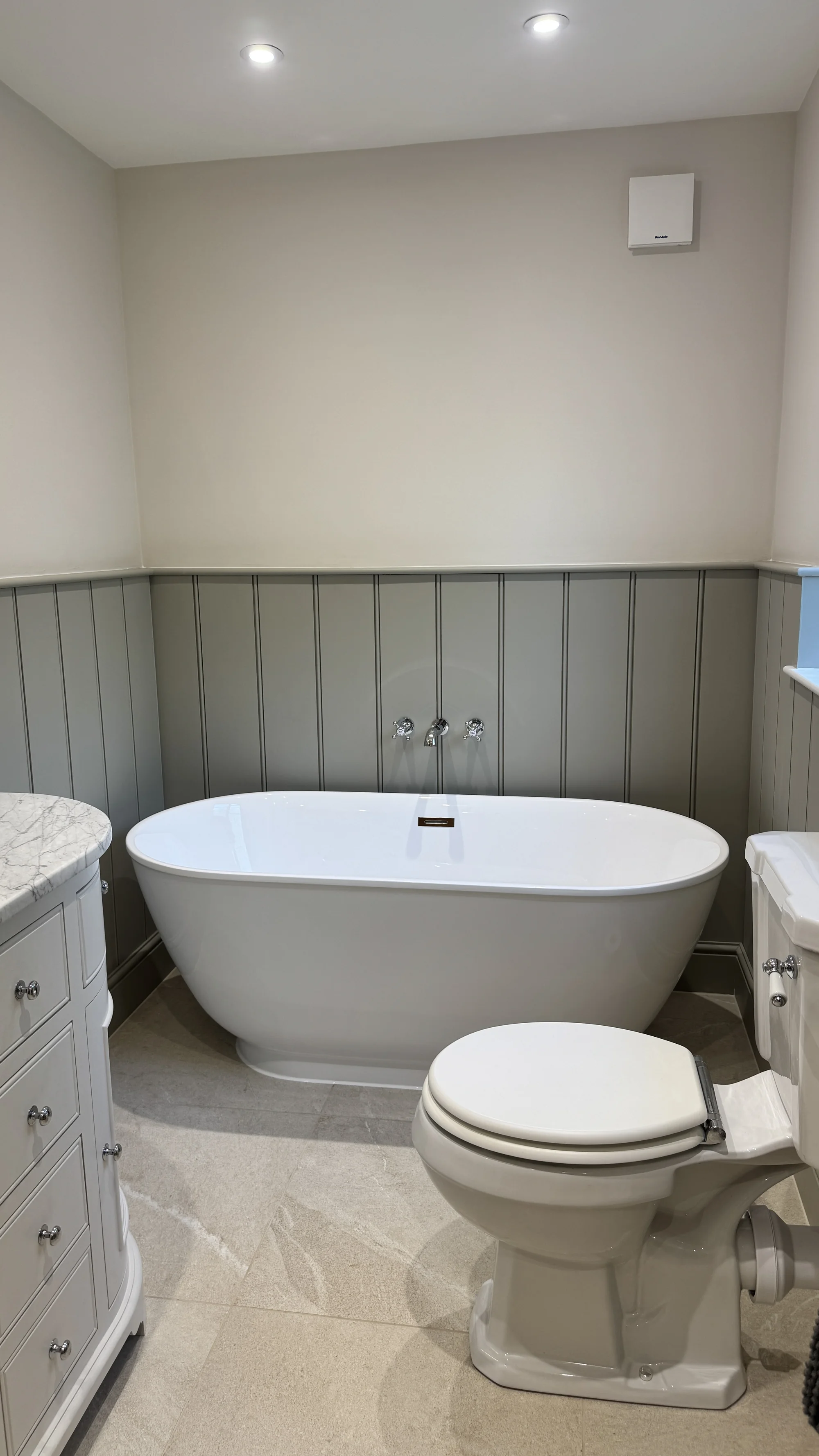 Freestanding bath and traditional WC against sage panelling, Baldock