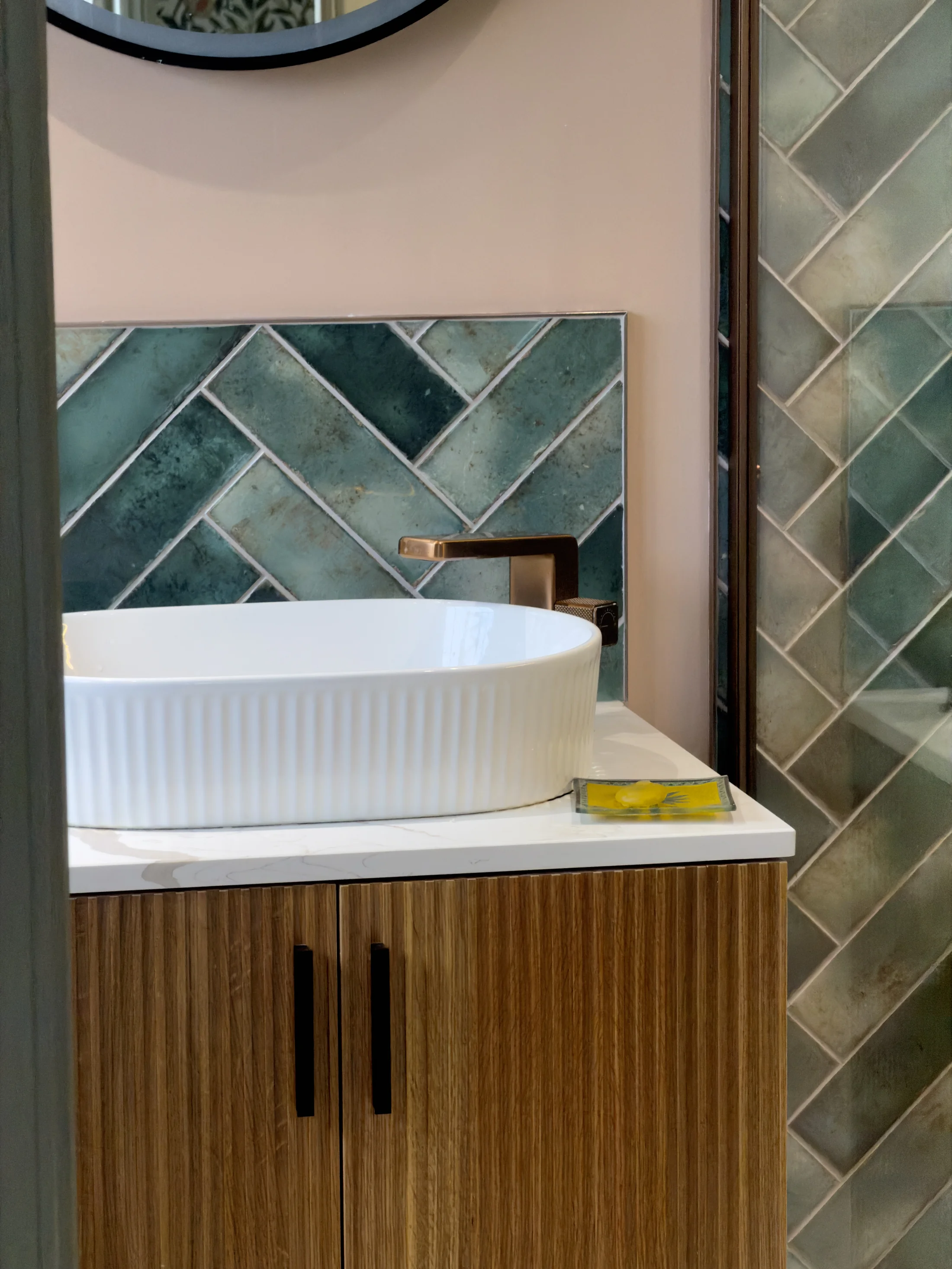 Countertop basin and fluted oak vanity with green herringbone splashback, St Albans