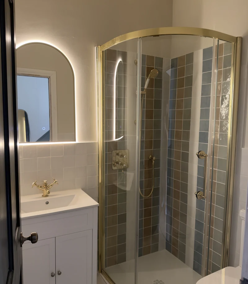 Brass-framed quadrant shower enclosure with mosaic tiling, Hitchin