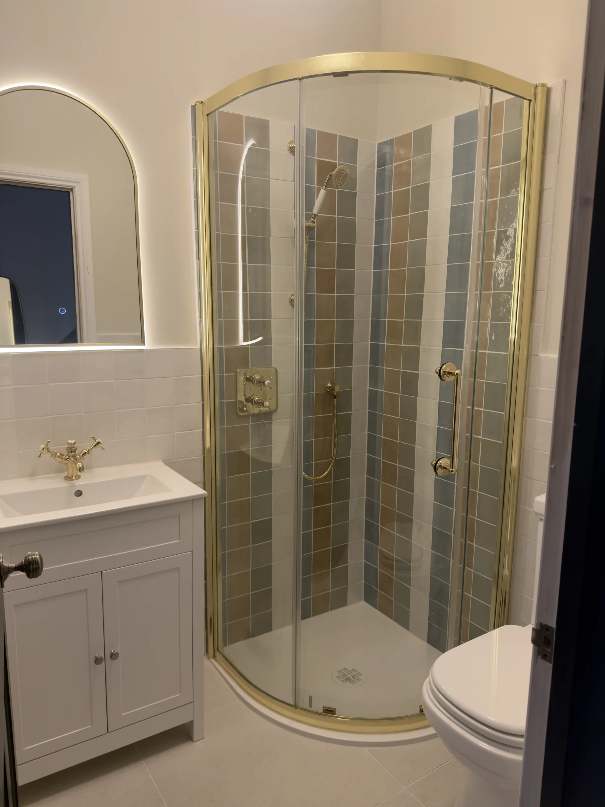 Bathroom installation with a brass-framed quadrant shower and shaker vanity, Hitchin