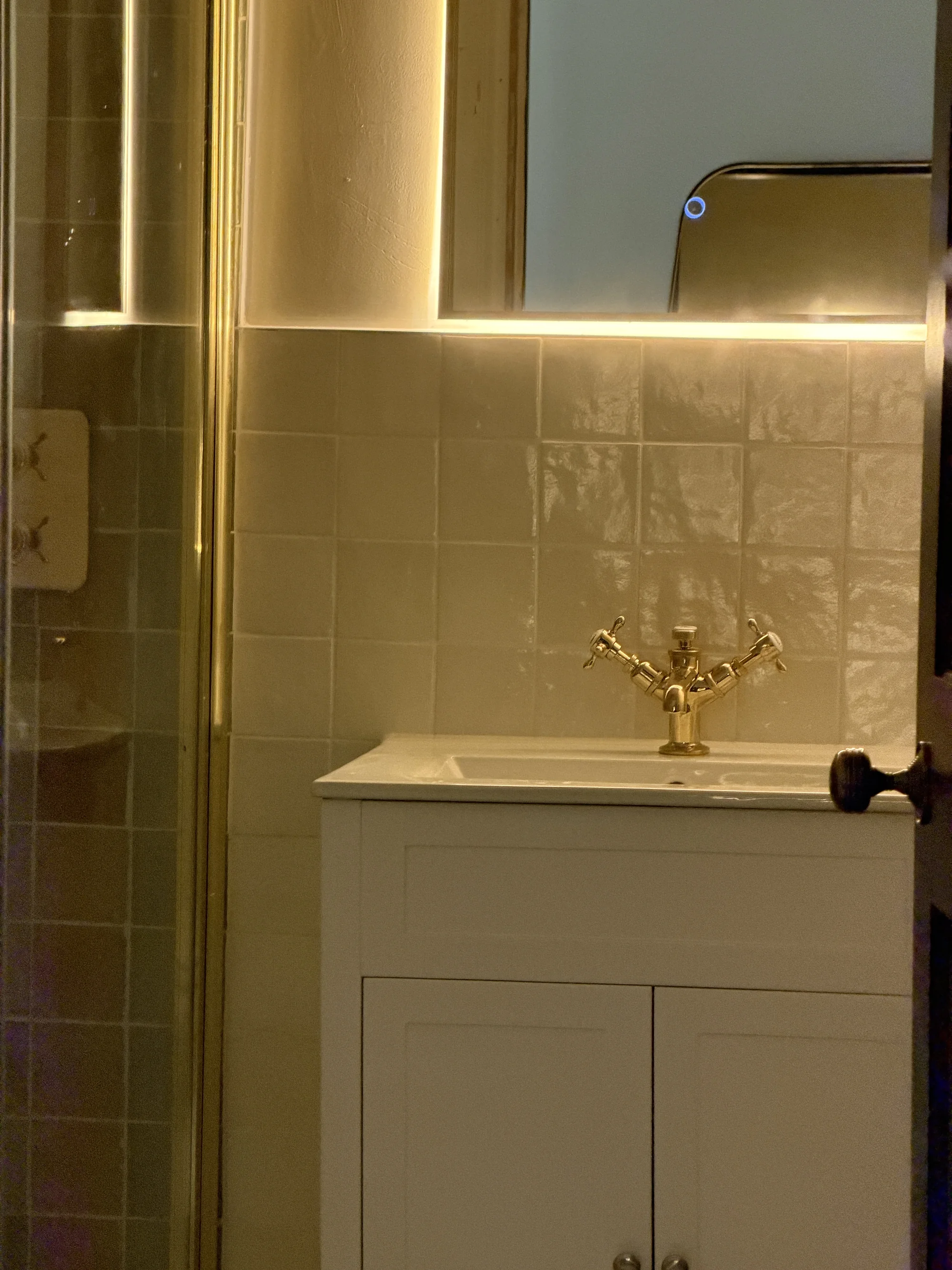 Warm-lit vanity and backlit mirror, bathroom installation Hitchin