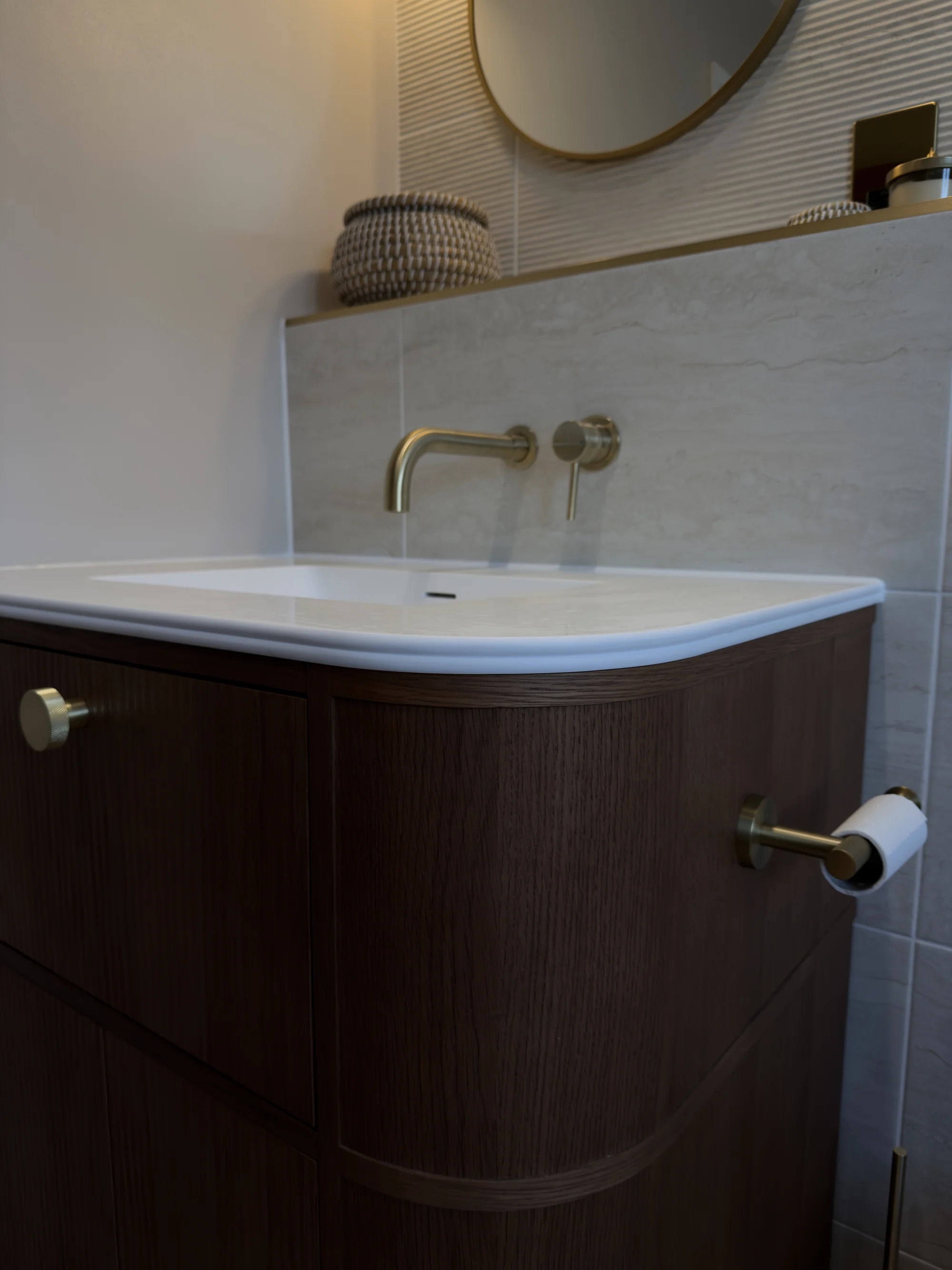 Wall-mounted brass taps and curved countertop basin, Weston