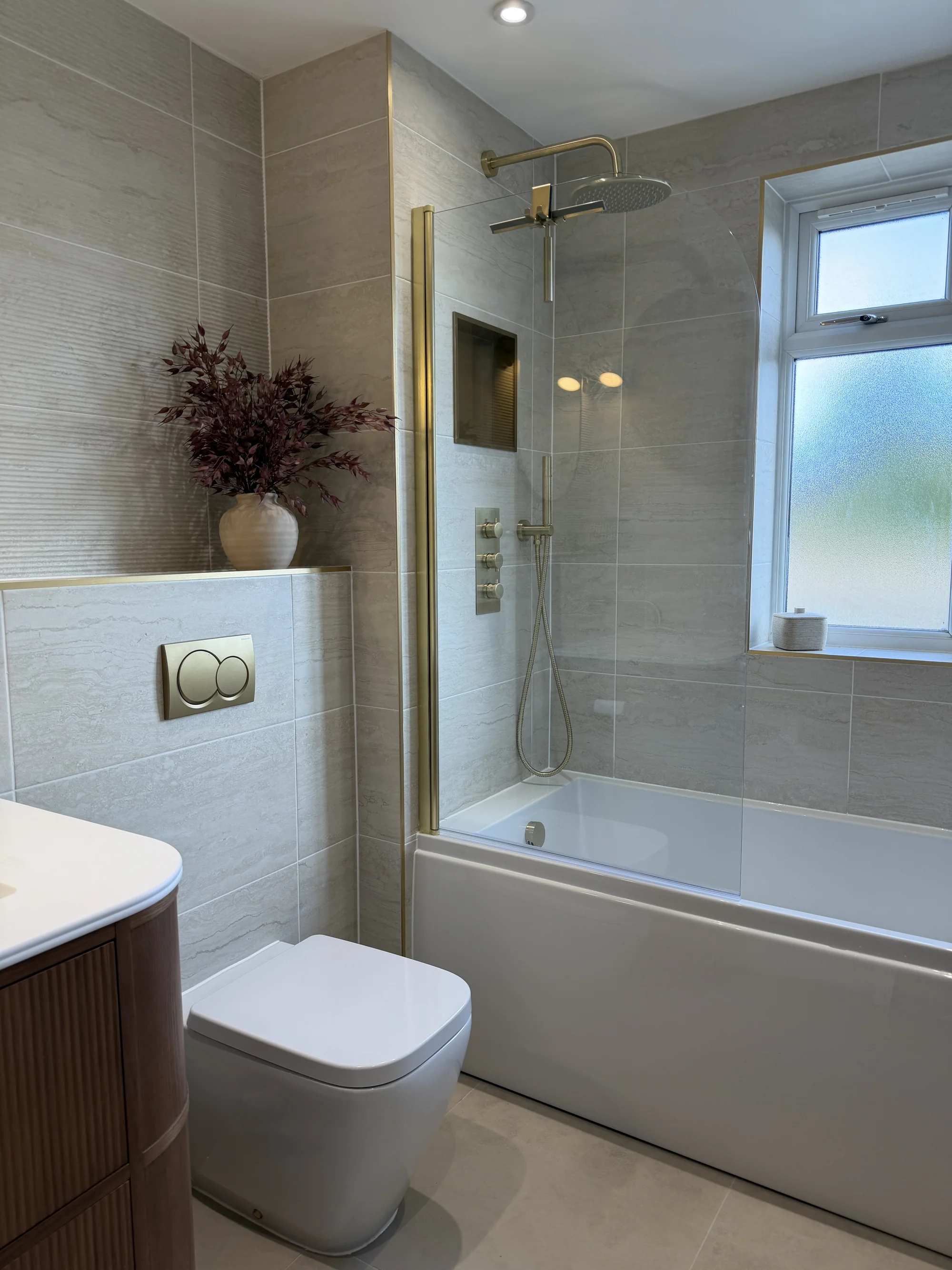Bath with brass shower over beside the window, Weston